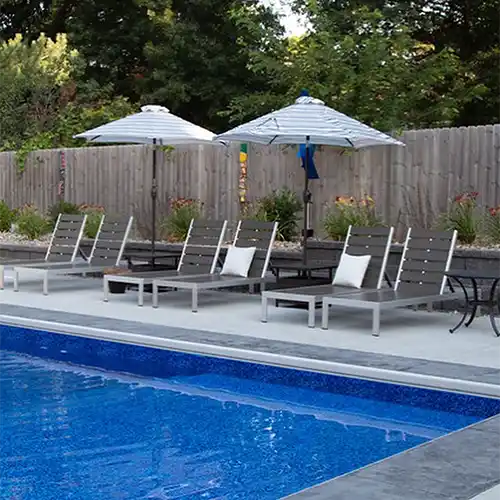 A seating area next to an outdoor pool