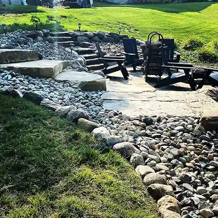 A stone staircase leads down to an outdoor seating area