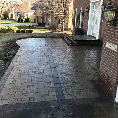 A patio area includes a decorative stonework design