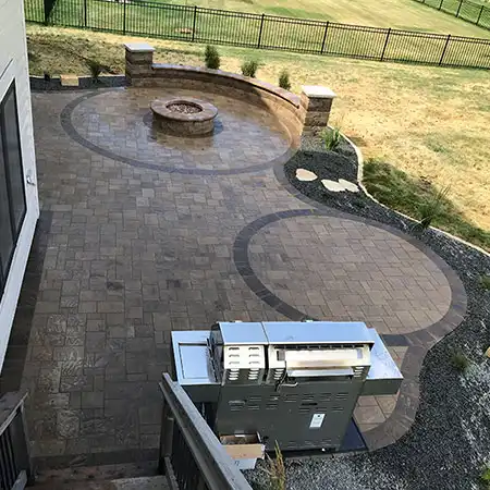A stone patio area with a fire pit