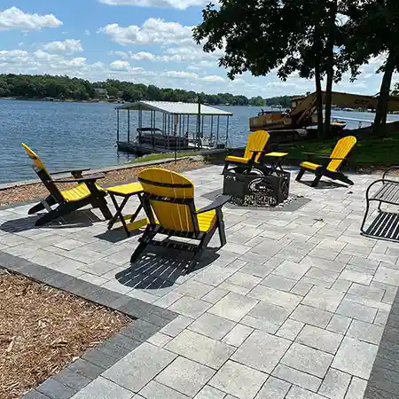 A stone outdoor seating area on the waterfront