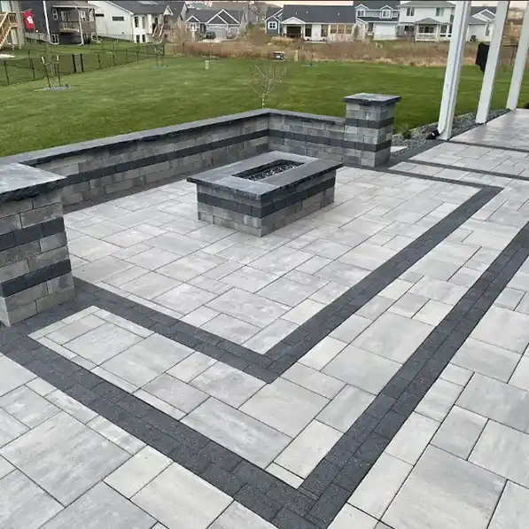 A stone patio area with a fireplace