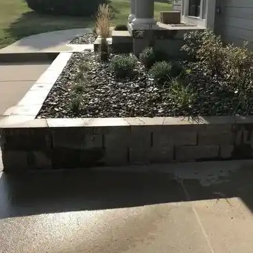 A raised garden bed made of stone