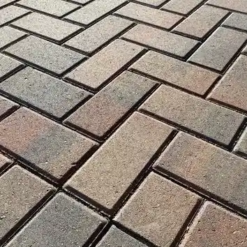 A close-up look at a designed patio floor made of stone pavers