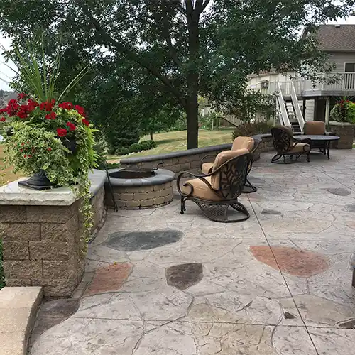 An outdoor seating area with a fire pit and tables