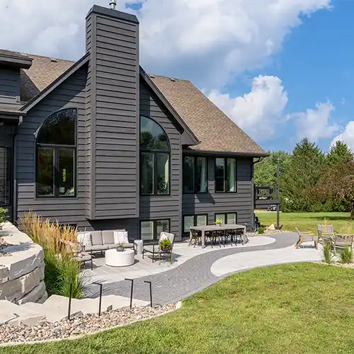 An outdoor living area with multiple seating areas, including an outdoor dining table